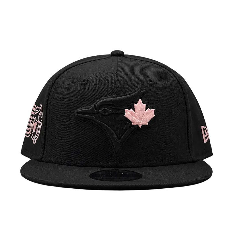 Black baseball cap with pink maple leaf logo on a white background