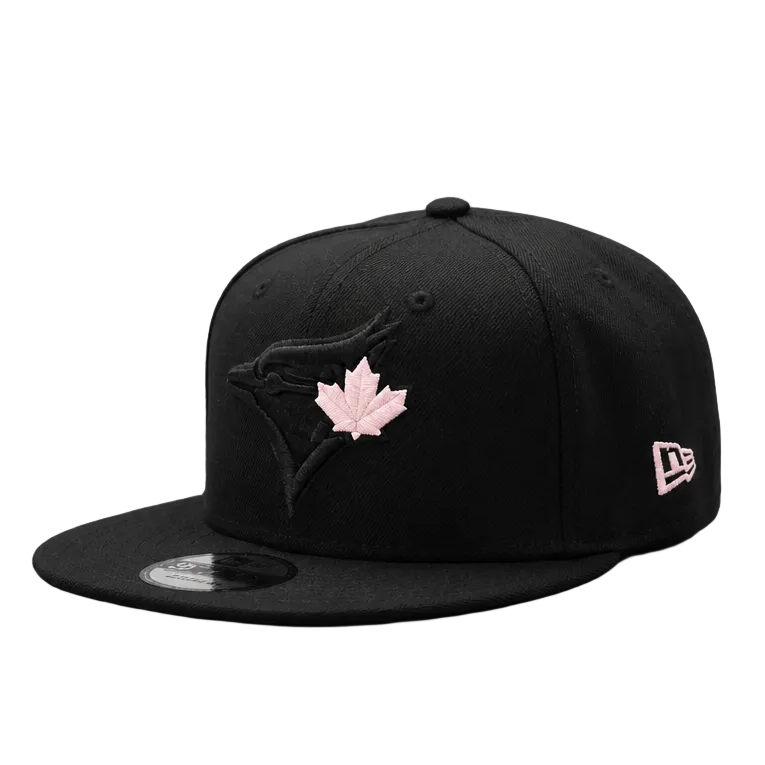 Black cap with pink maple leaf logo on a white background