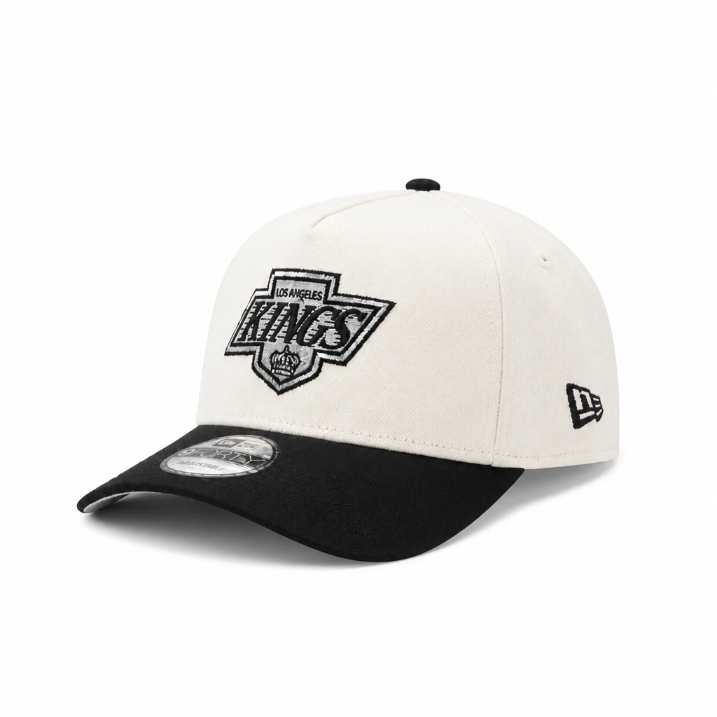 NEW ERA MEN'S 9FORTY A-FRAME NHL LOS ANGELES KINGS PRINCE OF WALES CONFERENCE CREAM/BLACK SNAPBACK HAT