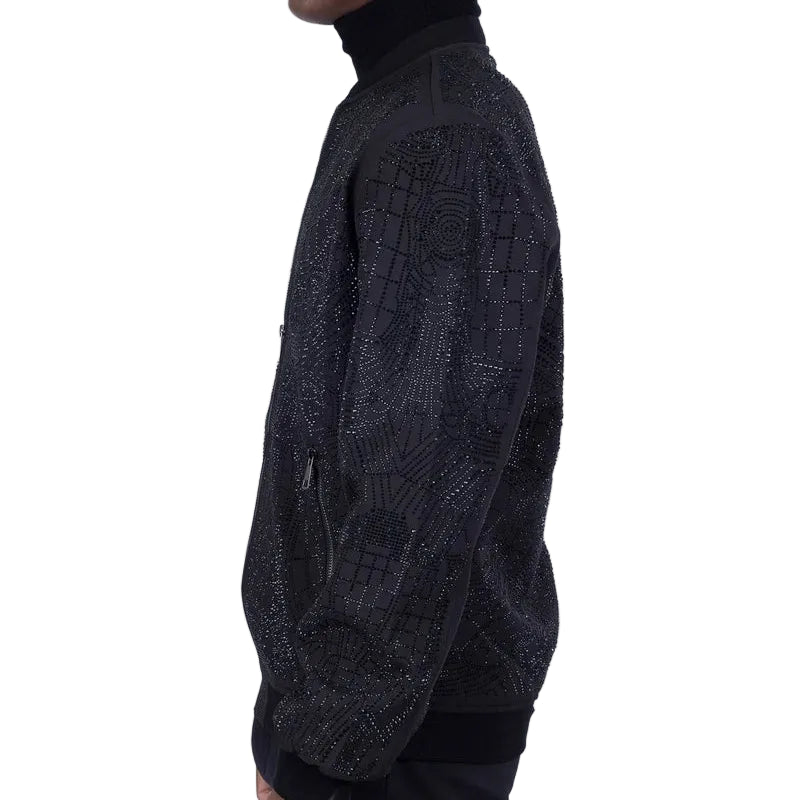 Man wearing a dark patterned jacket and turtleneck against a white background