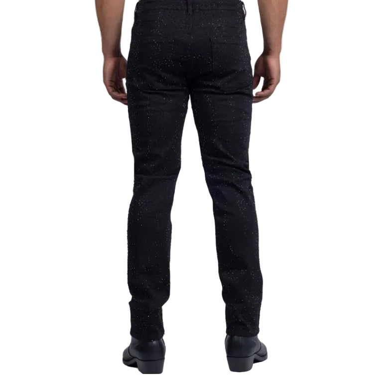 Person wearing black textured pants on a white background